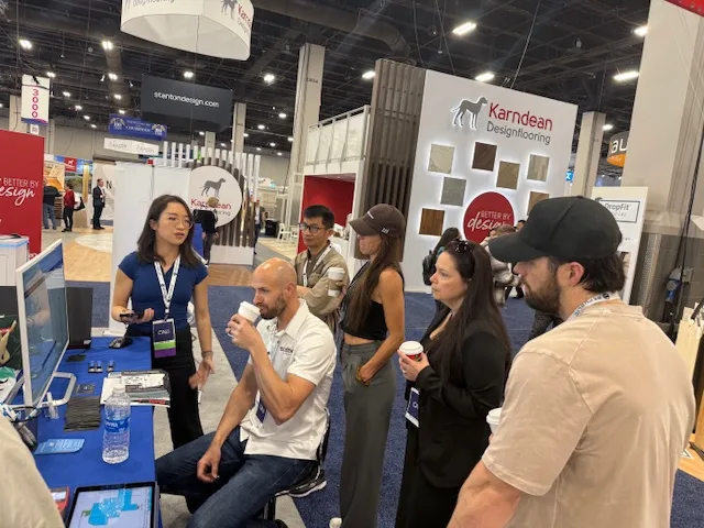 Jamie giving a product demo to a group of visitors at the booth